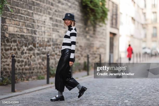 Karin Teigl wearing full comma fashion look, black Chanel bucket hat and black and white Louis Vuitton loafers on September 19, 2021 in Dusseldorf,...