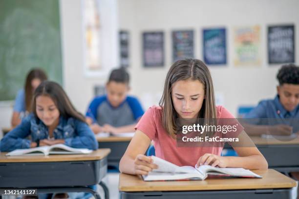 multi-ethnic high school students reading - teenager reading a book stock pictures, royalty-free photos & images