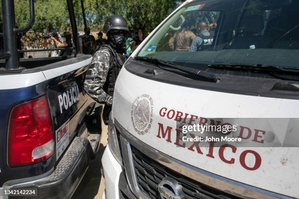 Mexican police deploy near the bank of the Rio Grande to stop migrants from crossing the U.S.-Mexico border on September 23 in Ciudad Acuna, Mexico....