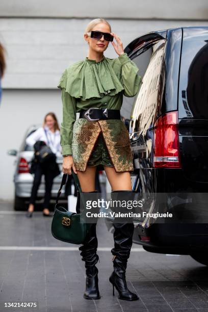 Leonie Hanne outside Etro fashion show wearing black thigh high boots , Etro mini skirt, and a green blouse with big collar during the Milan Fashion...