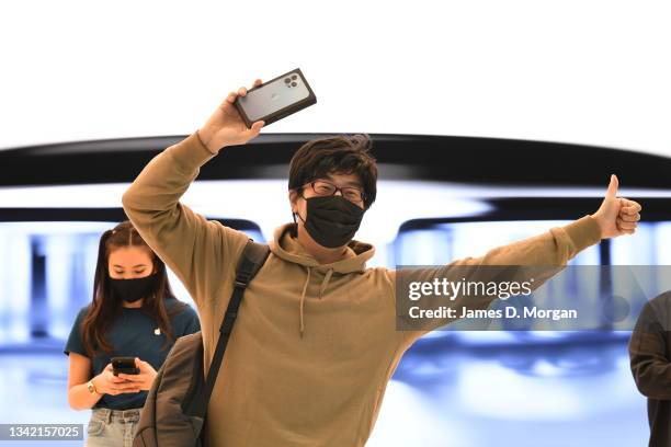 Jun Matsuda celebrates purchasing his new iPhone Pro inside the Apple Store on George Street on September 24, 2021 in Sydney, Australia. The new...