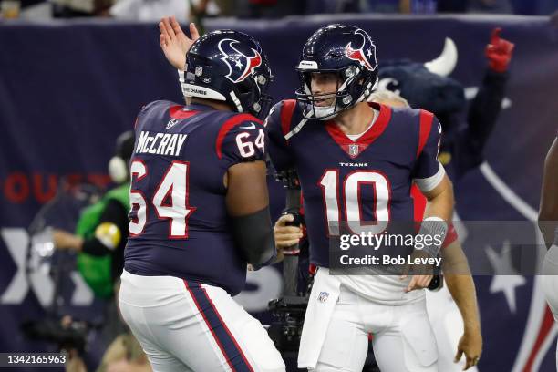 Davis Mills of the Houston Texans celebrates his second quarter touchdown pass with Justin McCray while playing the Carolina Panthers at NRG Stadium...