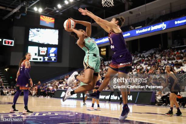 Betnijah Laney of the New York Liberty attempts a shot against Kia Nurse of the Phoenix Mercury during the first half of the first round WNBA...