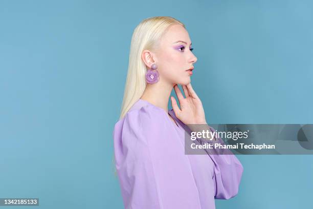 stylish woman in purple in dress - makeup and clothes stock-fotos und bilder