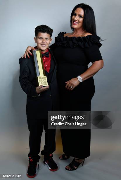 Kevin Randleman's son Santino and widow Elizabeth pose for a portrait backstage after Kevin was inducted into the UFC hall of fame during the UFC...