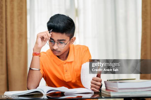 young boy preparing for exam, studying at home. - students studying stock pictures, royalty-free photos & images