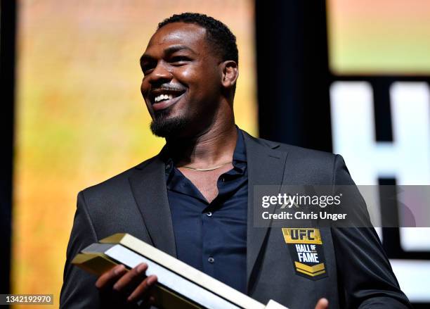 Jon Jones poses for photos on stage after being inducted into the UFC Hall of Fame during the UFC Hall of Fame Class of 2020 Induction Ceremony at...