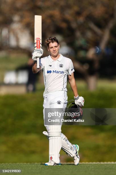 Cameron Green of Western Australia raises his bat after reaching his century during day one of the Sheffield Shield match between South Australia and...