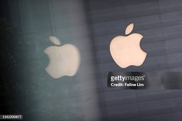 An Apple logo is reflected on glass at the Apple Store at Orchard Road on September 24, 2021 in Singapore. Apple announced September 14 the release...