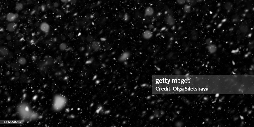 Falling snow on black background