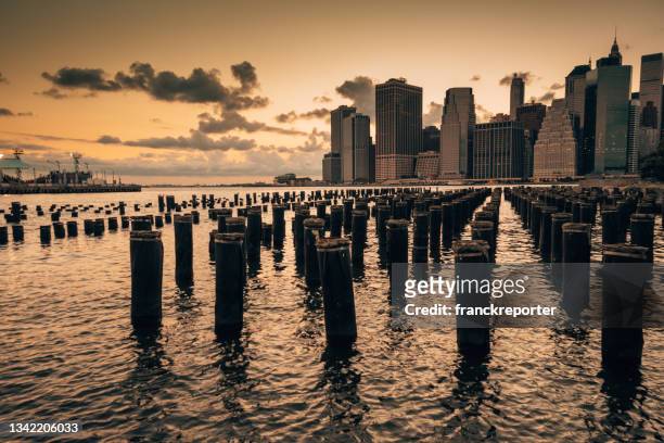 lower manhattan waterfront from brooklyn at dusk - dumbo new york stock pictures, royalty-free photos & images