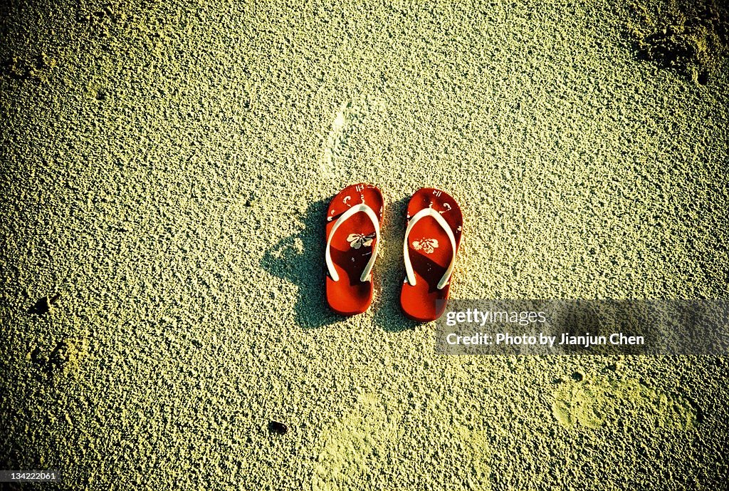 Red flip flop on beach