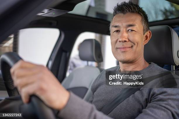 close-up of man driving car - driving bildbanksfoton och bilder