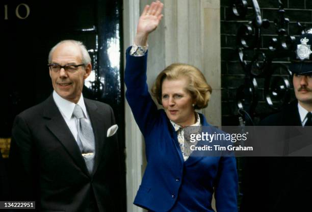 Prime Minister Margaret Thatcher, with husband Denis Thatcher, waves to well-wishers outside Number 10 Downing Street following her election victory,...