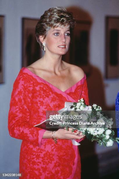 British Royal Diana, Princess of Wales , wearing a pink-and-red Catherine Walker suit, attends an unspecified event at the Barbican Centre in London,...