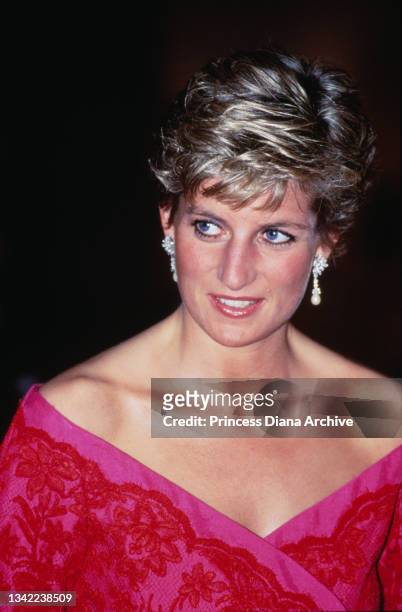 British Royal Diana, Princess of Wales , wearing a pink-and-red Catherine Walker suit, attends an unspecified event at the Barbican Centre in London,...