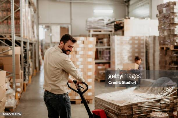 doing the warehouse work with a joy - middle class stock pictures, royalty-free photos & images