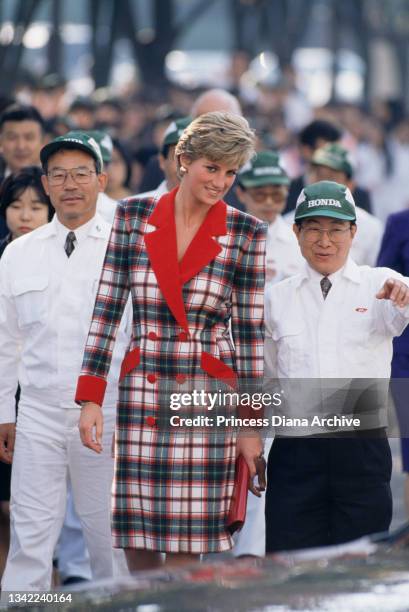 British Royal Diana, Princess of Wales , wearing a tartan Catherine Walker coatdress, with unspecified Honda employees during a visit to a Honda...