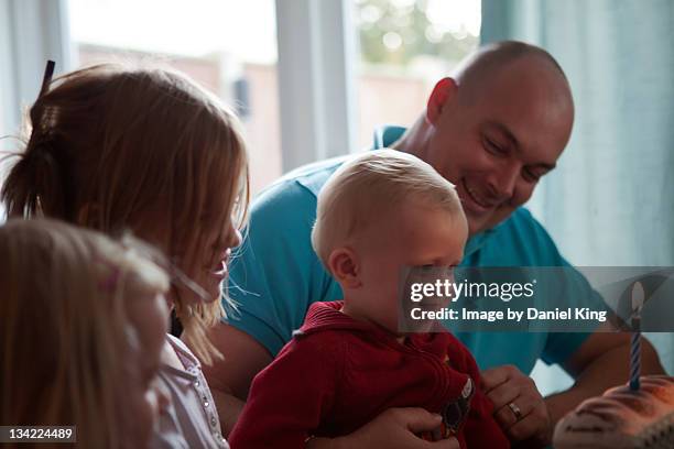 boy looking at cake - irish family stock-fotos und bilder