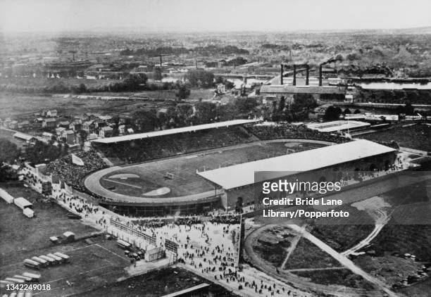 High angle view of crowds in and around the Stade Olympique Yves-du-Manoir , the Olympic stadium for the 1924 Summer Olympics, in Colombes, a suburb...
