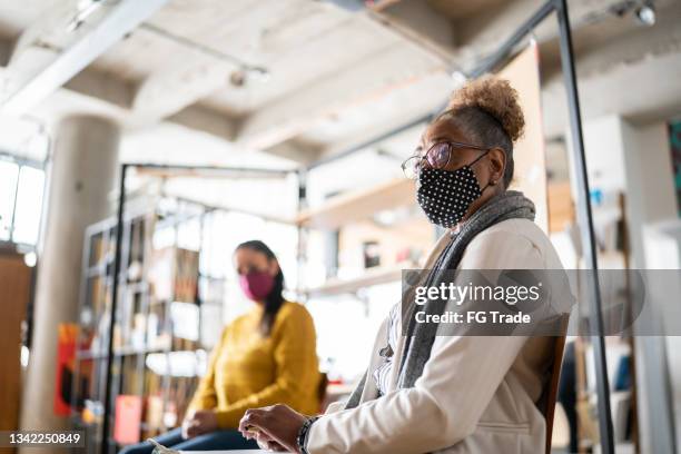 senior woman in group therapy at a coworking - wearing a face mask - employee engagement mask stock pictures, royalty-free photos & images