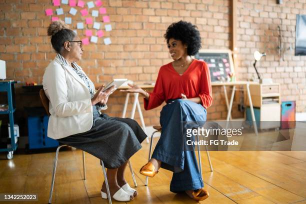 young woman with a senior psychologist or on a coach meeting - leadership conference day 1 stock pictures, royalty-free photos & images