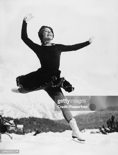 Norwegian figure skater and actress Sonja Henie takes flight as she leaps during the Ladies' Singles event at the 1936 Winter Olympics, held at the...
