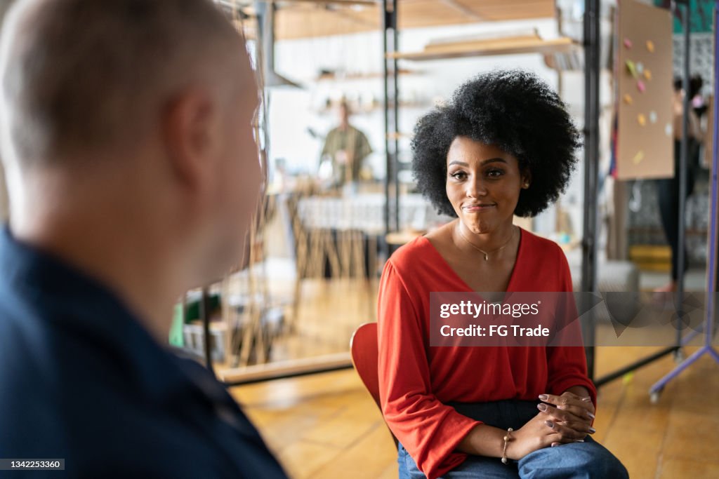 Young woman with a mature psychologist in a coworking