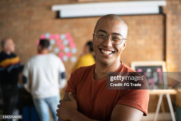 portrait of a young man at work - haarloos stockfoto's en -beelden