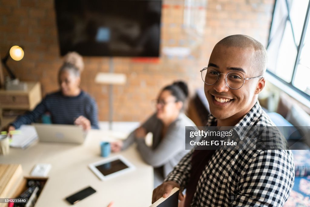 Portrait of a young man in a meeting at a coworking