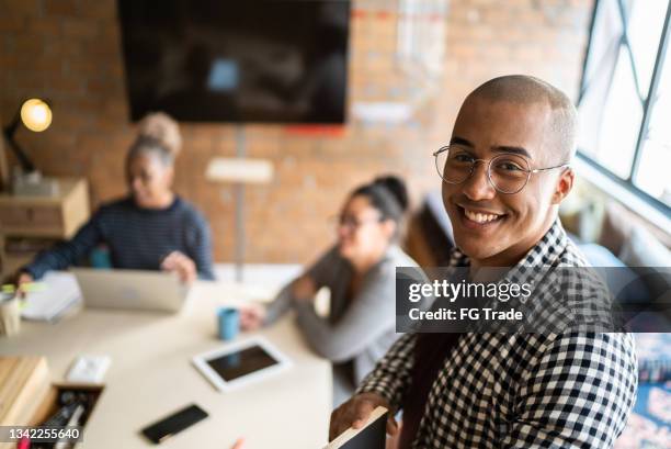 portrait of a young man in a meeting at a coworking - startup founder stock pictures, royalty-free photos & images