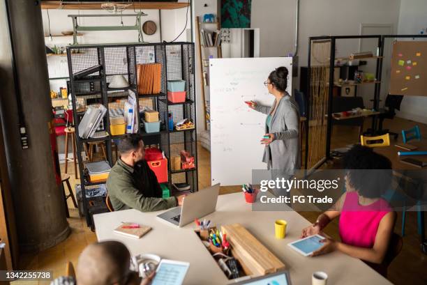 mature woman talking in a meeting at a coworking - working on laptop in train top view stock pictures, royalty-free photos & images