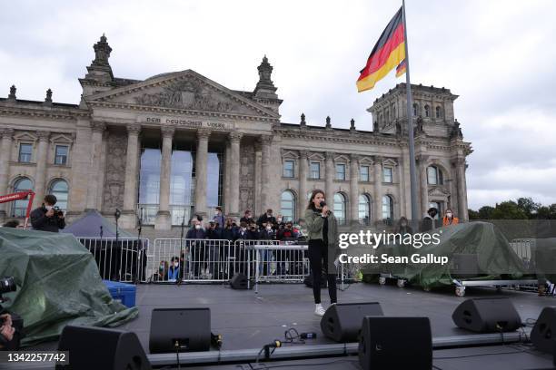 Climate activist Luisa Neubauer speaks at a large-scale climate strike march by Fridays for Future in front of the Reichstag on September 24, 2021 in...