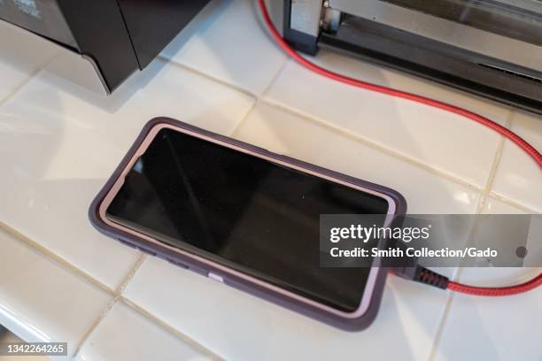 Samsung Galaxy smartphone in purple case charging on countertop, Lafayette, California, September 15, 2021.