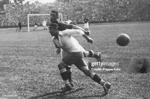 Uruguayan footballer Angel Romano in action against an unspecified Swiss footballer as Uruguay play Switzerland in the final of the men's football...