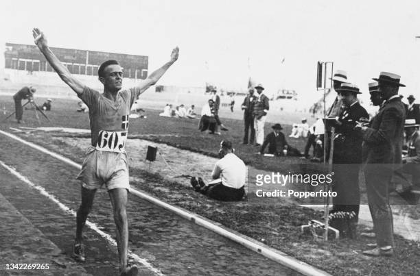 Italian race walker Ugo Frigerio , his arms raised in triumph after winning the second semifinal of the men's 10 kilometres walk event, at the Stade...