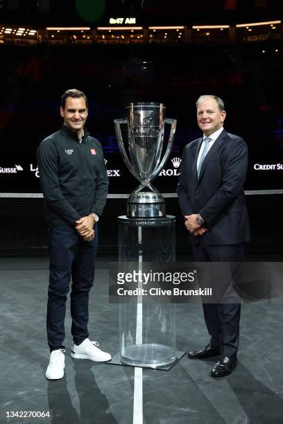 Roger Federer and Tony Godsick Laver Cup Chairman pose for a photograph with the Laver Cup Trophy after taking part in a live TV interview on CNBC at...