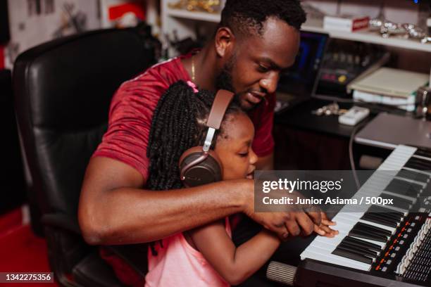 little girl playing in her fathers sound studio,tema,ghana - ghanaian family stock-fotos und bilder