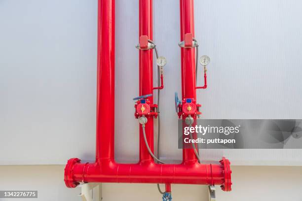 close-up of the red fire water control and distribution point - vintage fire extinguisher stock pictures, royalty-free photos & images