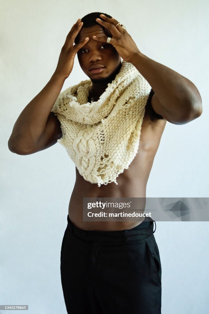 Young adult man with dark skin studio portrait.