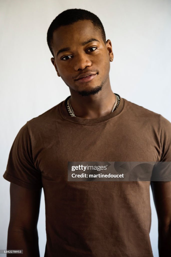 Young adult man with dark skin studio portrait.