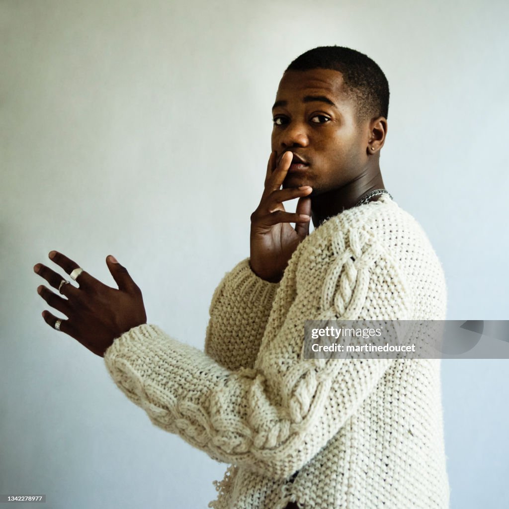 Young adult man with dark skin studio portrait.