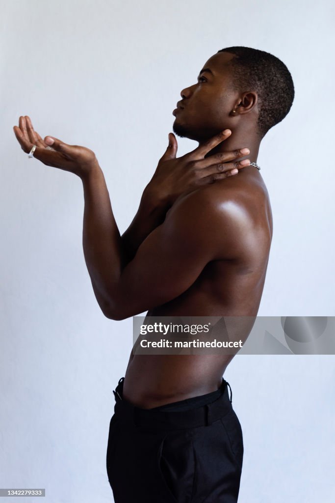 Young adult man with dark skin studio portrait.
