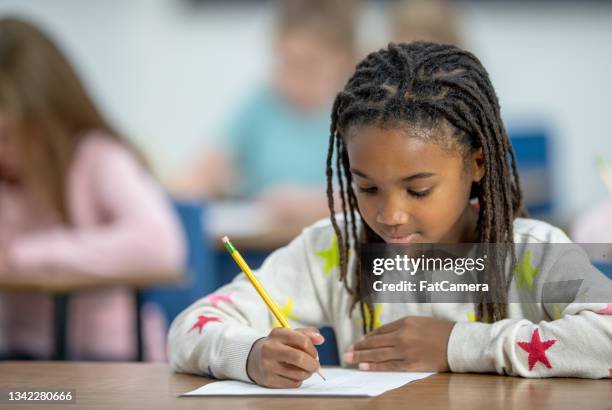 african elementary student writing - kid reading script stock pictures, royalty-free photos & images