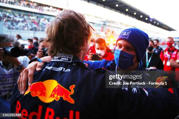 Second placed Dennis Hauger of Norway and Prema Racing celebrates winning the 2021 Formula 3 Championship with Mick Schumacher of Germany and Haas F1...