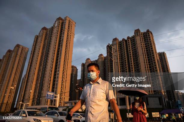 Man wears a mask while walking through the Evergrande changqing community on September 24, 2021 in Wuhan, Hubei Province, China. In 2015, Evergrande...