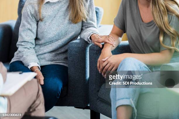 unrecognizable mother and her teen daughter talk with counselor - alternative therapy stock pictures, royalty-free photos & images
