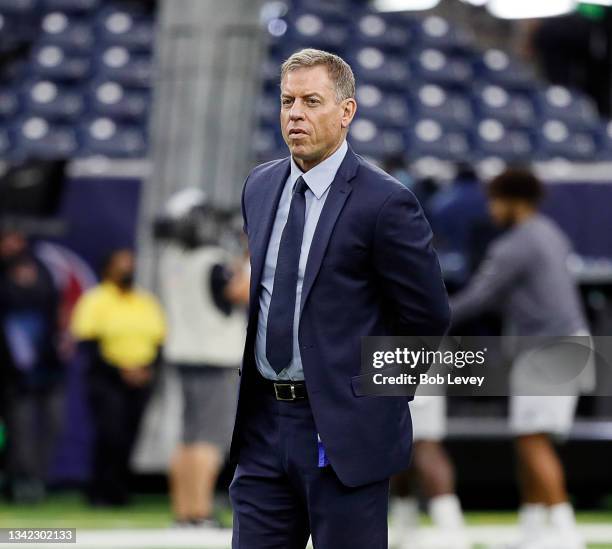 On FOX personality Troy Aikman watches warm ups prior to a game between the Carolina Panthers and the Houston Texans at NRG Stadium on September 23,...