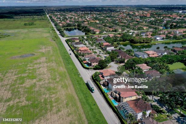 In an aerial view, Urban sprawl along SW 157 avenue is nestled next to protected wetlands and farmland on the fringes of Everglades National Park,...