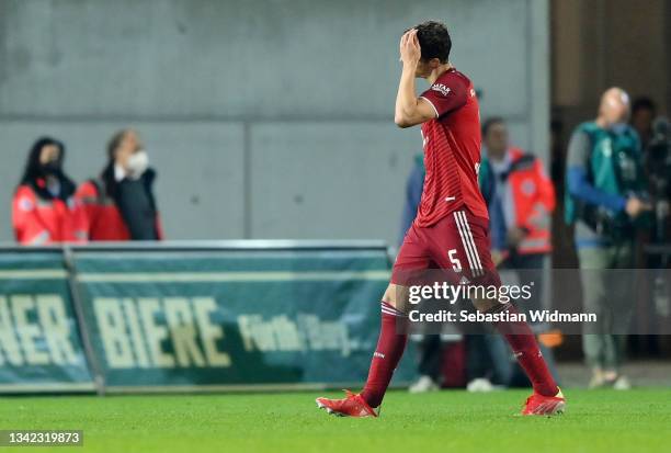 Benjamin Pavard of FC Bayern Muenchen walks off the pitch after being shown a red card and sent off during the Bundesliga match between SpVgg...